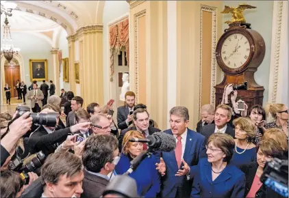  ?? AP PHOTO ?? A group of senators gather off the Senate floor to speak to reporters after reaching an agreement to advance a bill ending a government shutdown on Capitol Hill in Washington, Monday, Jan. 22, 2018. From left are, Sen. Tim Kaine, D-VA., Sen. Heidi...