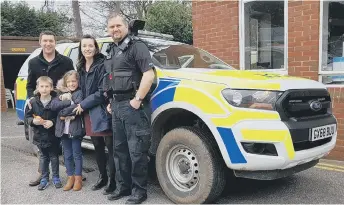  ??  ?? James and his family with Horsham police officers.