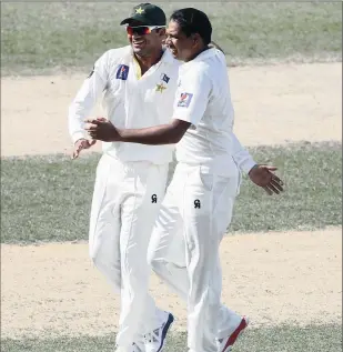  ?? PICTURE: GETTY IMAGES ?? CAPTURING A KIWI: Zulfiqar Babar, the bowler, and Azhar Ali of Pakistan celebrate the wicket of New Zealand’s Mark Craig during day two of the Second Test at Dubai Internatio­nal Stadium in the United Arab Emirates.