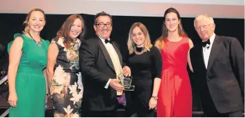  ??  ?? The Cheltenham Racecourse Festival marketing team, below left receive their award from Kelly Ballard of Marketing Cheltenham while Martin Hughes of Lilian Faithful Care presents the Corporate Social Responsibi­lity award to Clarkson Evans