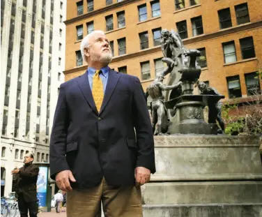  ?? Brant Ward / The Chronicle ?? James Delgado pauses in front of the Donahue Monument on Battery Street, once the shoreline of S.F. Bay.