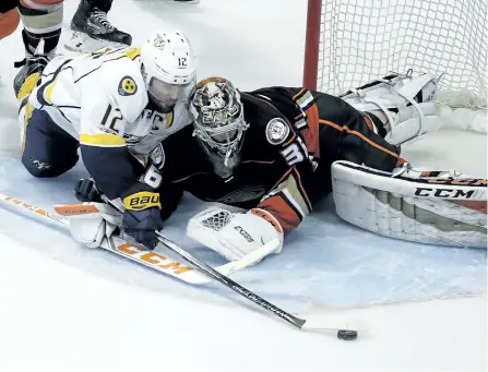  ?? CHRIS CARLSON/THE ASSOCIATED PRESS ?? Anaheim Ducks’ goalie John Gibson blocks a shot by Nashville Predators’ captain Mike Fisher during the second period of Game 2 of the Western Conference final in the NHL hockey Stanley Cup playoffs, on Sunday, in Anaheim, Calif. The Ducks won 5-3 and tie the series 1-1.