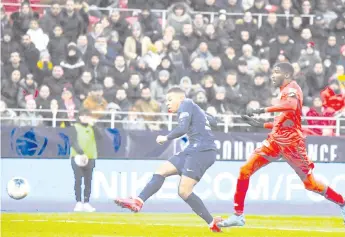  ??  ?? Mbappe (left) scores a goal during the French Cup quarter final football match Dijon (DFCO) vs Paris SaintGerma­in (PSG) on February 12, 2020 at the Gaston Gerard stadium in Dijon. - AFP photo