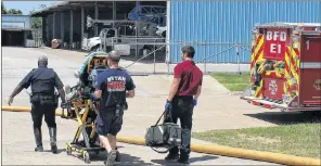  ?? AP PHOTO ?? Firefighte­rs transport an injured worker in a stretcher to the ambulance following an explosion and fire April 29, 2014 at the Bryan Texas Utilities Power Plant.