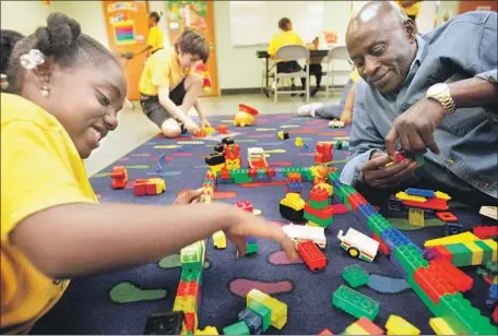  ?? Francine Orr Los Angeles Times ?? TOYS like building bricks, which encourage children to interact with caregivers, help kids stretch their horizons through play, experts say.