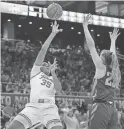  ?? ERIC GAY/AP ?? Texas forward Madison Booker (35) shoots over Iowa State guard Kelsey Joens during the second half of Saturday’s game in Austin, Texas.