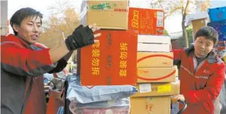  ??  ?? Delivery men put packed commoditie­s on their motors on the morning of November 12 morning, a day after a nationwide online shopping spree on the Singles Day, a folk holiday when online retailers offer great promotions. — Xinhua