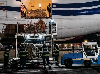  ?? Brendan Hoffman / New York Times ?? Workers unload a shipment of U.S. military aid at the internatio­nal airport in Boryspil, Ukraine. President Joe Biden said Russian President Vladimir Putin “continues to build forces along Ukraine’s border.”