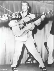  ?? ?? This 1956 photo of Elvis Presley performing was used for his first RCA Victor album cover. The King of Rock ’n’ Roll would be 88 today had he lived.