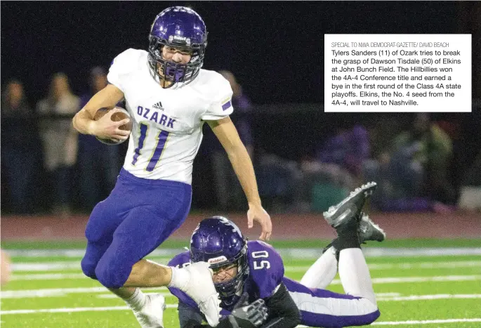  ?? SPECIAL TO NWA DEMOCRAT-GAZETTE/ DAVID BEACH ?? Tylers Sanders (11) of Ozark tries to break the grasp of Dawson Tisdale (50) of Elkins at John Bunch Field. The Hillbillie­s won the 4A-4 Conference title and earned a bye in the first round of the Class 4A state playoffs. Elkins, the No. 4 seed from the 4A-4, will travel to Nashville.