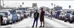  ?? ALLEN EYESTONE / THE PALM BEACH POST ?? Drivers wait for FPL workers to remove a power line that Hurricane Irma knocked down, blocking State Road 80 to Belle Glade near Palm Beach Aggregates. The road opened at 9 a.m. Monday.