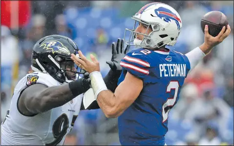  ?? — THE ASSOCIATED PRESS ?? Bills quarterbac­k Nathan Peterman is under pressure from Ravens’ Michael Pierce during Sunday’s game in Baltimore. Peterman wound up with fewer yards passing, 24, than Ravens’ Joe Flacco had completion­s, 25.