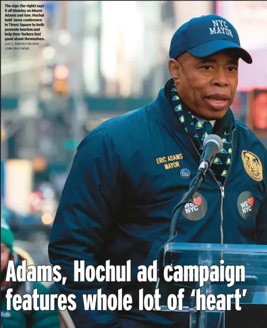  ?? LUIZ C. RIBEIRO FOR NEW YORK DAILY NEWS ?? The sign (far right) says it all Monday as Mayor Adams and Gov. Hochul hold news conference in Times Square to both promote tourism and help New Yorkers feel good about themselves.