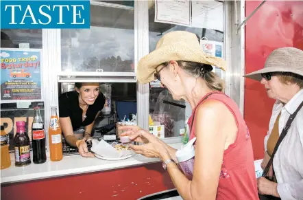  ?? PHOTOS BY JANE PHILLIPS/FOR THE NEW MEXICAN ?? Andrea Dobyns, left, serves Barbara Cataldo her order of Waffle Cristo at Santafamou­s Street Eats, a food truck that Dobyns and Joseph Baca opened in May at the corner of Old Santa Fe Trail and Paseo de Peralta.