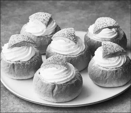  ?? PHOTOS BY ARMANDO RAFAEL / THE NEW YORK TIMES ?? Many Swedes enjoy cream-filled, cardamom-scented semlor this time of year. The treat follows the Christian tradition of using up animal-based supplies before Lent.