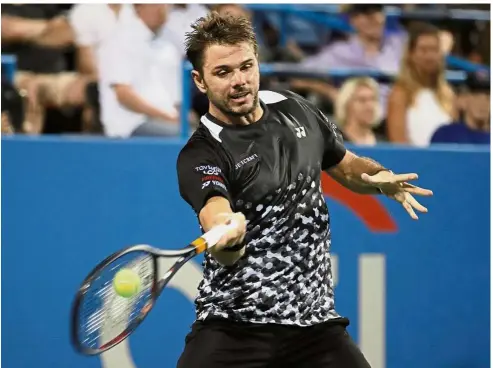  ?? — AP ?? Back to you: Stan Wawrinka returning a shot to Donald Young during the first round of the Washington Open on Tuesday.