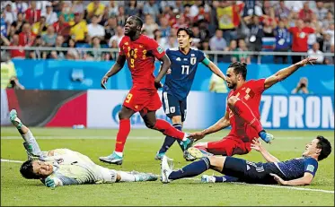  ?? AP/NATACHA PISARENKO ?? Belgium’s Nacer Chadli (second from right) scores a goal past Japan goalkeeper Eiji Kawashima (far left) during Monday’s round of 16 match at the World Cup at Rostov Arena in Rostov-on-Don, Russia. Chadli’s goal gave Belgium a 3-2 victory.