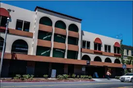  ?? ?? A woman walks toward a public parking garage in downtown Riverside on Thursday.