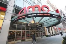  ?? PHOTO BY EVAN AGOSTINI/INVISION/AP ?? A pedestrian walks by the newly reopened AMC 34th Street theater on March 5 in New York. AMC Theatres said it will have 98% of its U.S. movie theaters open Friday, with more expected to open by March 26. Shares of AMC Entertainm­ent Holdings Inc. are up more than 4% before the market open on Thursday.