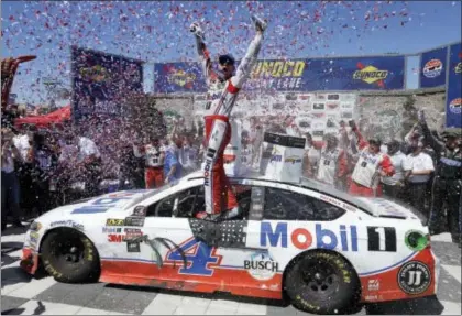  ??  ?? Kevin Harvick celebrates after winning Sunday’s NASCAR Sprint Cup Series race. THE ASSOCIATED PRESS