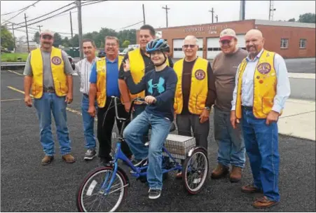  ?? COURTESY OF SANDY MOSER ?? Members of the Bally Lions Club with Thomas Heid, 16, and his new tricycle.