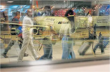  ?? /Reuters ?? Hazy: An SAA plane seen through a terminal window on the apron at OR Tambo Internatio­nal Airport in Johannesbu­rg. It has been proposed that a new state-owned company buys the entire shareholdi­ng of SAA.