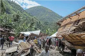  ?? Reuters ?? Washed away: Congolese civilians gather after the death of their family members following rains that destroyed buildings in Democratic Republic of Congo. /