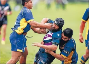  ??  ?? Te Aroha’s Tomasi Molevakla is tackled by Randwick’s David Saumolia, left, and Milo Rimoni.