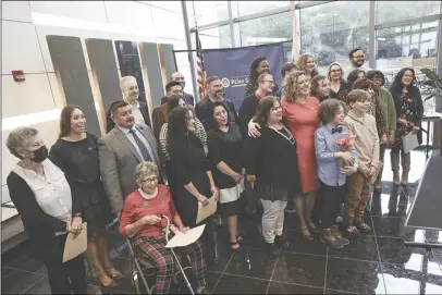  ?? Chris Torres/ The Signal ?? (Above) State Assemblywo­man Pilar Schiavo, DChatswort­h, takes a group photo with elected officials and guests at her community swearing-in ceremony held at the College of the Canyons University Center on Saturday. (Right) Schiavo (left) gets sworn in by Speaker of the Assembly Anthony Rendon, DLakewood, who also named Schiavo the new assistant majority whip at the ceremony.