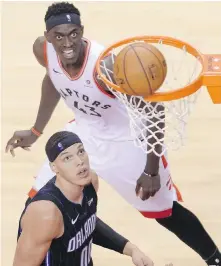  ?? THE CANADIAN PRESS ?? Orlando forward Aaron Gordon, foreground, and Toronto forward Pascal Siakam watch as Siakam’s shot fails to drop.