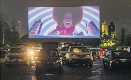  ?? THE CANADIAN PRESS ?? Cars are lined up to watch a movie at the re-opening of the St-Eustache Drive-In on Friday in St-Eustache, Que.