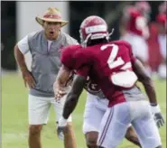  ?? VASHA HUNT — AL.COM VIA AP ?? Alabama coach Nick Saban works with his players during NCAA college football practice Aug. 16in Tuscaloosa, Ala.