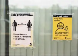  ?? Tyler Sizemore / Hearst Connecticu­t Media ?? Signs promote social distancing and masks on the platform of the Metro-North station in downtown Greenwich on Sept. 14. Monday was the first day Metro-North began issuing $50 fines to passengers not wearing masks.