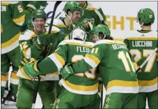  ?? STACY BENGS — THE ASSOCIATED PRESS ?? Wild goaltender Marc-andre Fleury celebrates with teammates after defeating the Predators in overtime on Sunday in St. Paul, Minn.