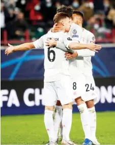  ?? — AFP photo ?? Bayern Munich’s Kimmich celebrates with teammates after scoring the team’s second goal during the UEFA Champions League match against Lokomotiv Moscow in Moscow.