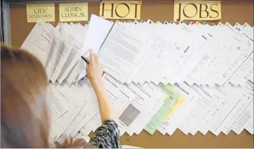  ?? Mark Boster Los Angeles Times ?? PEOPLE WHO SWITCH jobs more often early in their careers have higher incomes later in life, according to a 2014 study for the National Bureau of Economic Research. Above, a job listings board in Glendale in 2013.