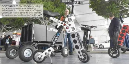  ?? CYCLE THAT FOLDS: —AFP ?? The URB-E electric folding bicycle is on display inside the Technology Pavilion at the 2017 LA Auto Show in Los Angeles, California, on Tuesday before the event opens to the public running from December 1 to 10.