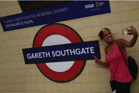  ??  ?? A passenger takes a selfie at Southgate Undergroun­d Station, temporaril­y renamed as ‘Gareth Southgate’ in honour of the England manager