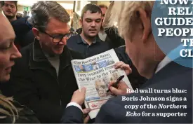  ??  ?? Red wall turns blue: Boris Johnson signs a copy of the Northern Echo for a supporter