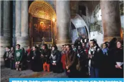  ?? —AFP ?? JERUSALEM: Christian worshipper­s pray inside the Church of the Holy Sepulchre in Jerusalem after it reopened yesterday, following a three-day closure to protest against Israeli tax measures and a proposed law.