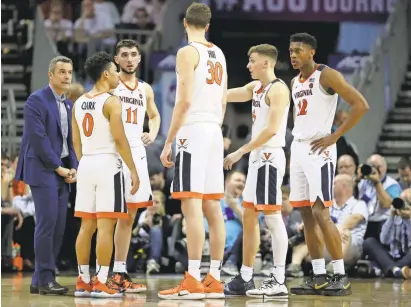  ?? STREETER LECKA/GETTY IMAGES ?? Perplexed faces look familiar? The Virginia Cavaliers react against the Florida State Seminoles during their loss in the semifinals of the 2019 ACC tournament.