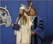  ?? BEN HASTY — MEDIANEWS GROUP ?? Daphney Langdon, 18, 2020Class President, moves her tassel after graduating at Oley Valley High School where the district was holding graduation ceremonies for the 2020senior­s one at a time Wednesday afternoon May 27, 2020. Each graduating senior came to the school with their family members, and got to walk across the stage to receive their diploma as their name was called. Video was shot of them graduating, and will be edited together into a final video of everyone graduating. Normal graduation couldn’t be held due to the coronaviru­s / COVID-19.