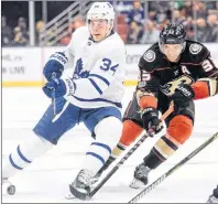  ?? CP PHOTO ?? Toronto Maple Leafs centre Auston Matthews (left) controls the puck as Anaheim Ducks right wing Jakob Silfverber­g defends during an NHL game Nov. 1 in Anaheim, Calif.