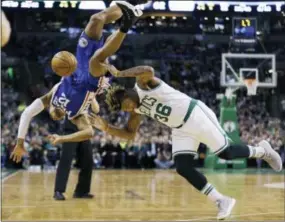  ?? ELISE AMENDOLA — THE ASSOCIATED PRESS ?? Sixers guard Gerald Henderson falls over Boston Celtics guard Marcus Smart in the second quarter Friday.