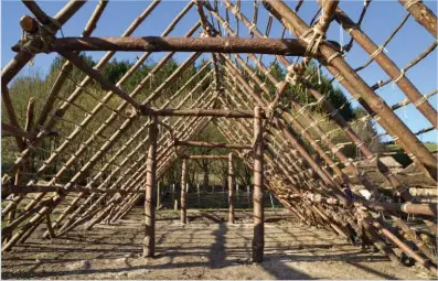  ??  ?? Below: Paired posts support the roof at either end and in the centre
Left: Tools and technologi­es known to have been available to the original builders were used in the project; here a wood joint is cut with a flint-bladed axe