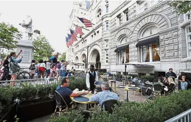  ??  ?? Raising a ruckus: Protesters yelling at patrons at the outdoor seating area at the Trump Internatio­nal Hotel, where Trump is attending a fund-raiser.