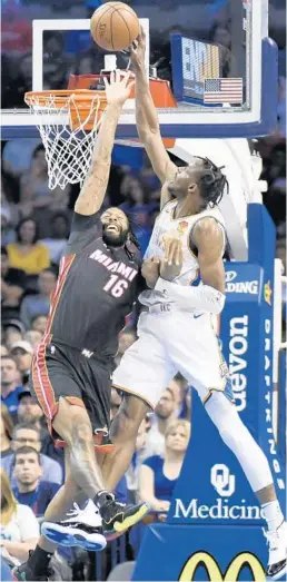  ?? KYLE PHILLIPS/AP ?? Heat forward James Johnson, (16) tries to block a shot by Thunder forward Jerami Grant (9) in the first half of Monday’s game in Oklahoma City.