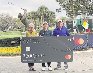  ?? PGA ?? Thailand’s Jazz Janewattan­anond, centre, poses with a mock cheque after his hole-in-one. TOUR