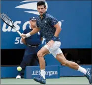  ?? AP/CAROLYN KASTER ?? Novak Djokovic returns a shot to Joao Sousa during the fourth round of the U.S. Open on Monday in New York. Djokovic won 6-3, 6-4, 6-3 to reach the quarterfin­als for an 11th consecutiv­e appearance in New York as he bids for a third U.S. Open championsh­ip and 14th Grand Slam trophy.