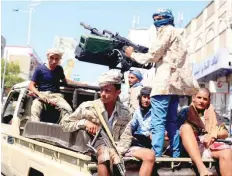  ?? — Reuters file photo ?? Government soldiers ride on the back of a patrol truck on a street where people demonstrat­ed against the deteriorat­ion of Yemen’s economy and the devaluatio­n of the local currency in Taiz recently.